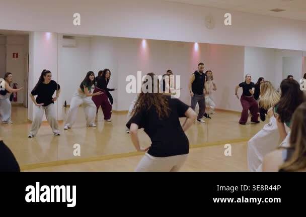 Group of diverse young dancers following a choreographers instructions ...