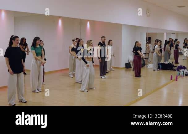 Energetic group of diverse young dancers following a choreographers ...