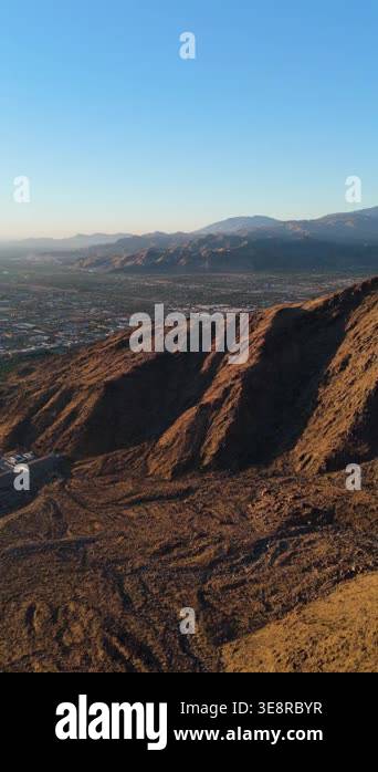 Vertical drone footage captures a breathtaking sunrise flight over a ...