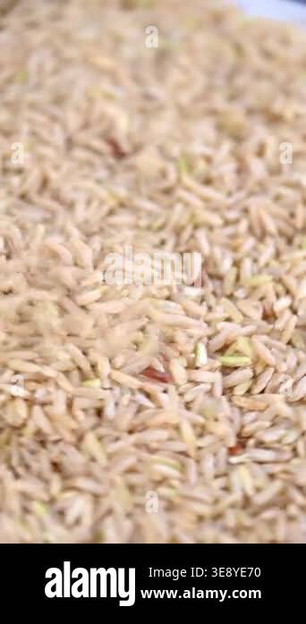 Example Of Puring Rice Pouring brown rice overhead: closeup sequence of grain movement and ...