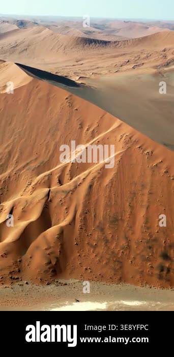 Aerial drone view of endless sand dunes stretching across the Namib ...