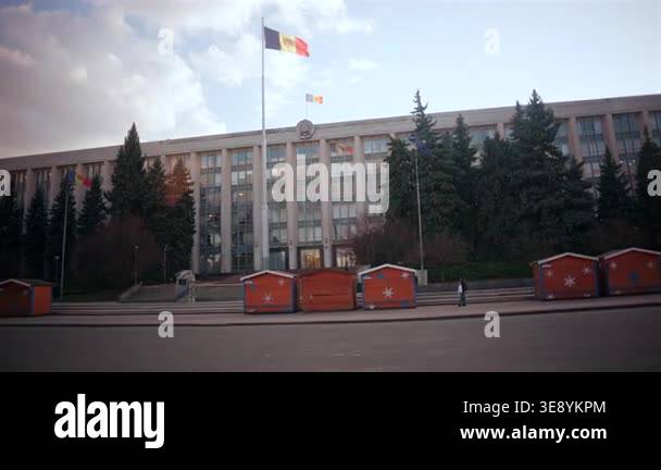 Wide shot from a moving car of the Government building in Chisinau ...