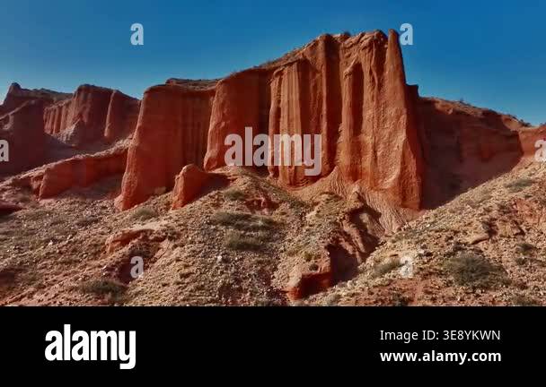 This image displays a dramatic desert landscape featuring massive ...