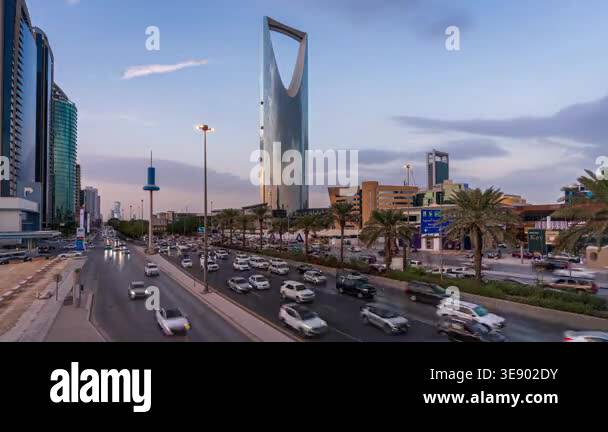 Day to night time lapse clip of traffic on a main road in central ...