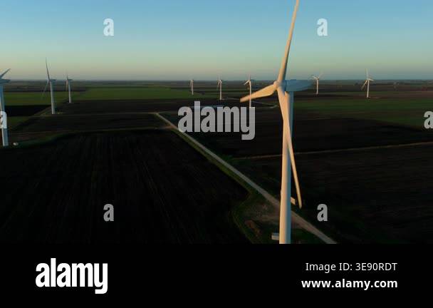 Aerial drone view of a huge wind farm in a rural agricultural landscape ...