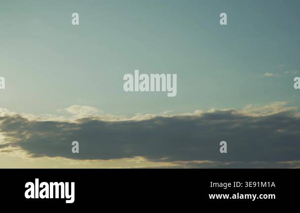 A panoramic view of soft, dramatic clouds drifting across a deep blue ...
