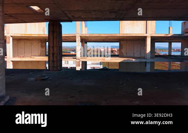 Interior of unfinished concrete building with view of landscape. View ...