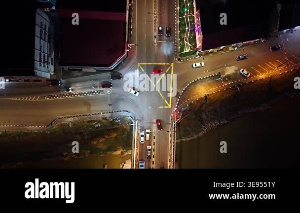 Segamat Riverside Night. View Top-down night drone shot of Segamat intersection and riverside bridge ...