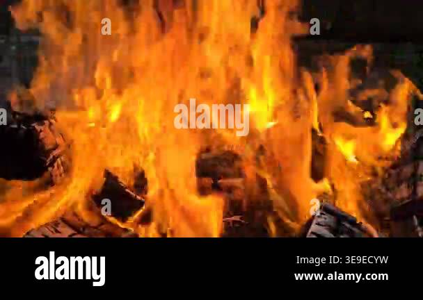 fire in the fireplace. bright flames burning firewood in close view ...