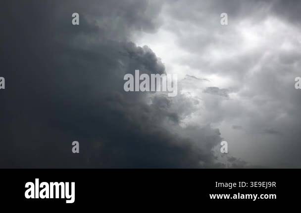 Dark storm clouds race across the sky in timelapse, building a dramatic ...