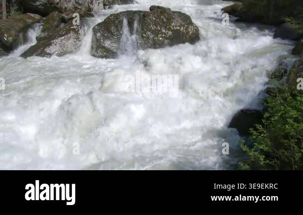 Water Rushing Through Rocks Rushing river water crashing through forest rocks foam spray powerful ...