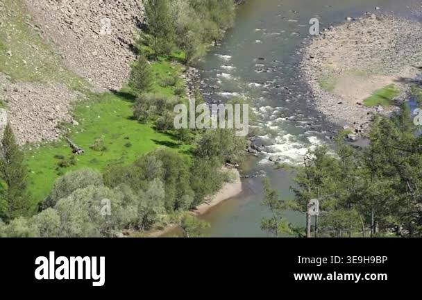 River flows along a deeply incised rocky valley shaped by long term ...