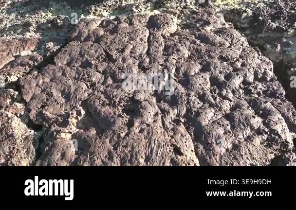 Frozen basalt lava rocks showing porous vesicular texture formed by ...
