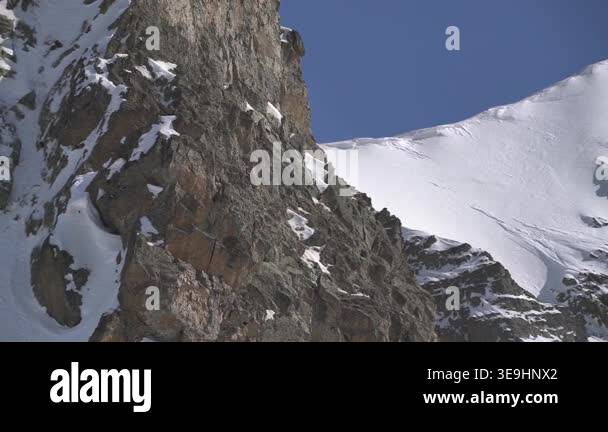 Panoramic snowy mountain range shows jagged rocky peaks, ridgeline ...