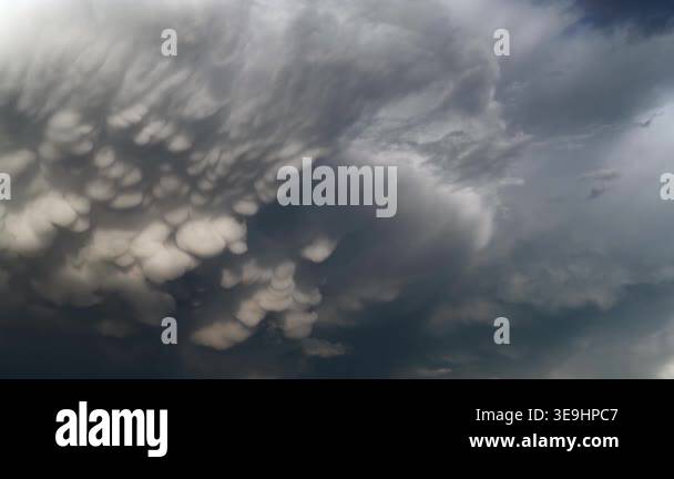 Panoramic mammatus clouds create dramatic storm sky texture across a ...