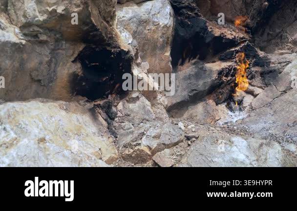 Burning Mathane Burning methane flame emerges from rock crack as natural gas leaks from ...