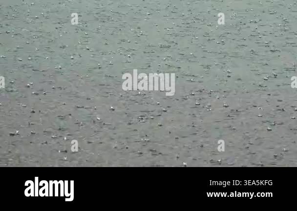 Rough hail impacts water surface during intense rainy storm weather ...