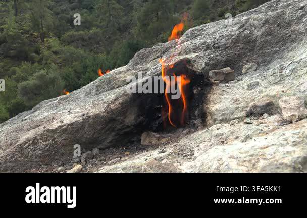 Flame of burning methane gas emerging from underground rock crack in ...