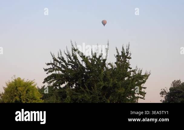 Single white hot air balloon flying high in the sky with clean minimal ...