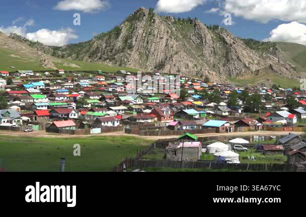 Mongolian ger tents stand in wide steppe meadow, showing traditional ...