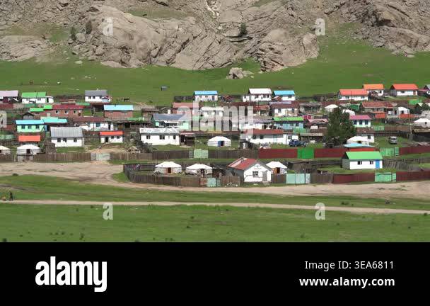 Mongolian ger tents stand in wide steppe meadow, showing traditional ...