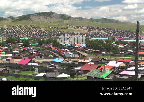 Mongolian ger tents stand in wide steppe meadow, showing traditional ...