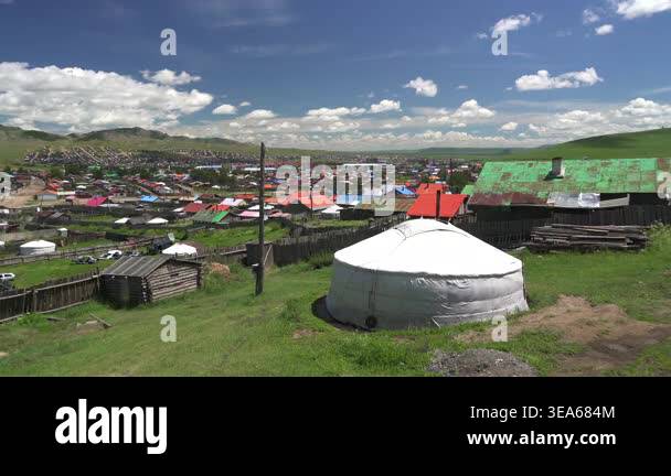 Mongolian ger tents stand in wide steppe meadow, showing traditional ...