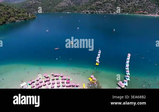 Bright coastal scenery shows clear sea water and broad shoreline ...