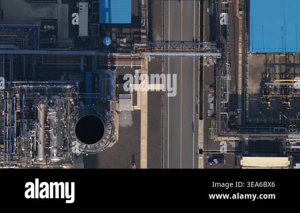 Top down aerial view moving forward along a road through a large ...