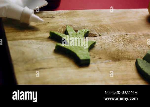 Pesto flavored cheese carved into pineapple leaf patterns Stock Video ...