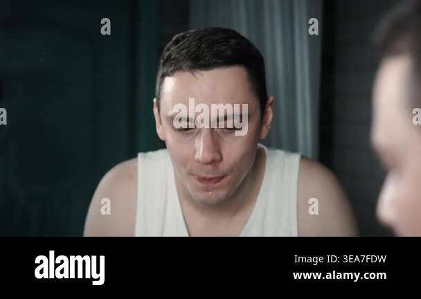 A European-looking man spends the morning in the bathroom performing ...