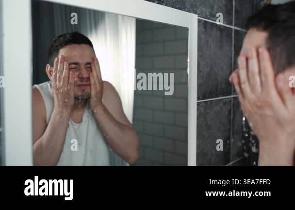 A European-looking man spends the morning in the bathroom performing ...