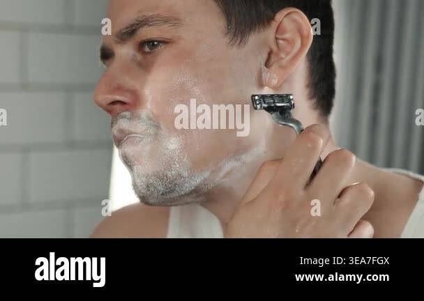 A European-looking man spends the morning in the bathroom performing ...