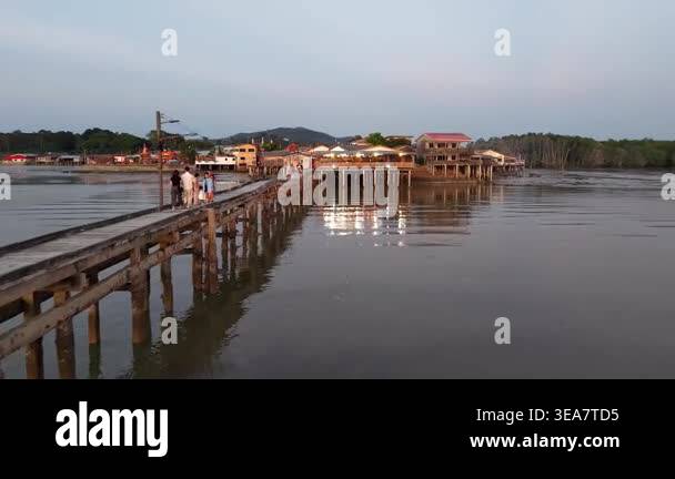 Segenting, Johor, Malaysia - Mar 07 2026: People walking on a wooden ...