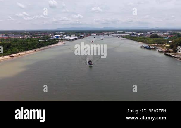 Endau, Johor, Malaysia - Mar 27 2026: Riverboat slices through calm ...