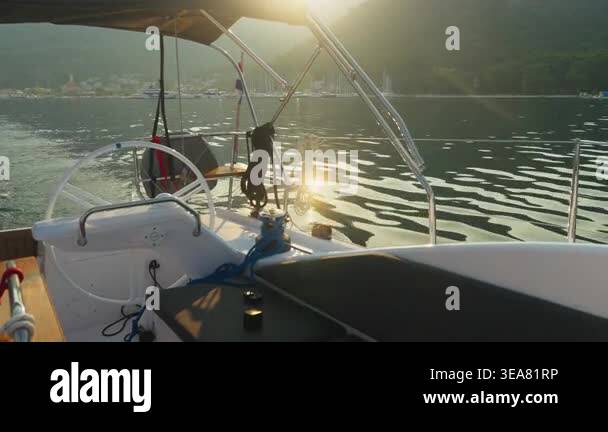 Sunlit Cockpit Overlooking Calm Wake, Lifebuoy Hanging Near Rail ...