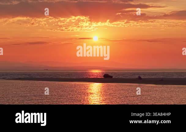Aerial view of the golden sunset over Epanomi beach sandbar with calm ...