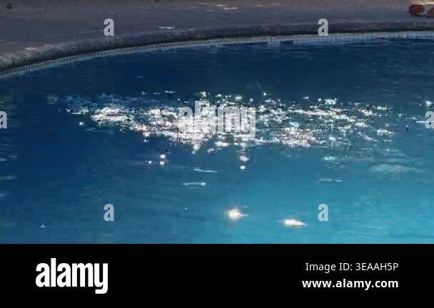 Blue Swimming Pool Water With Bright Sun Sparkles and Gentle Ripples ...