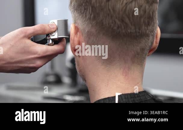 Close up of barbers hands using electric razor, creating precise ...