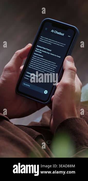 Close up of a man holding a smartphone, using an AI chatbot app for ...