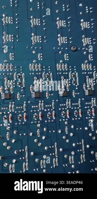A close-up view of a blue printed circuit board filled with surface ...