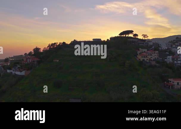Golden hour timelapse of a scenic hillside town in Madeira at sunset ...