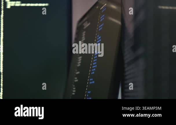 Close-up of computer monitors displaying source code with highlighted ...