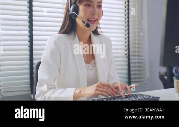 Woman wearing headset working on computer Stock Video Footage - Alamy