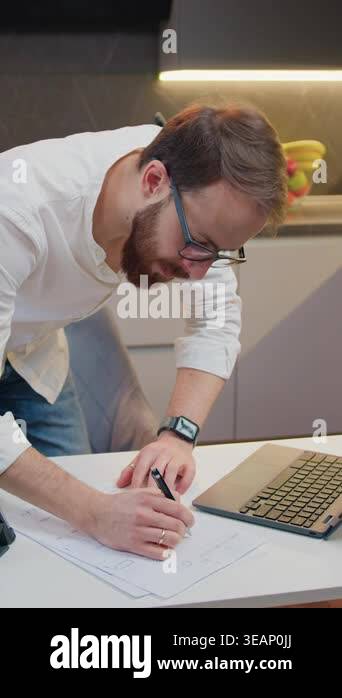 Top view. Man hands which holding pen drawing lines on large paper ...
