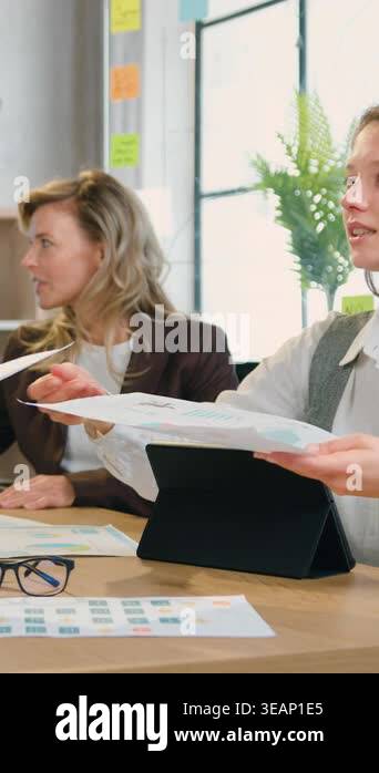 Group of successful caucasian and african women colleagues analyze ...