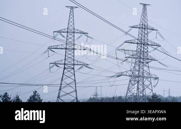 Electric voltage towers, power line, electricity pylon at winter snow ...