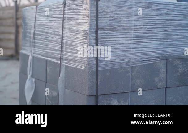Construction blocks on pallet wrapped in stretch film close-up. High ...