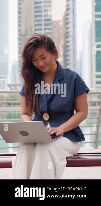 Vertical video of Asian Real estate agent woman taking a work break ...
