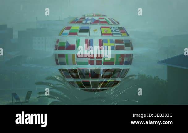 Hovering international flags sphere over tropical landscape in ...
